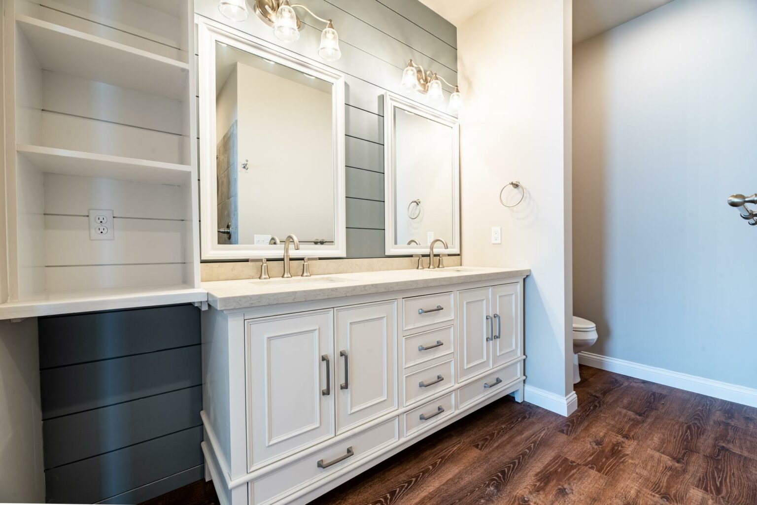 Double vanity with tailored cabinetry and open shelving